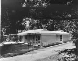a front view of a house with a yard and outdoor seating