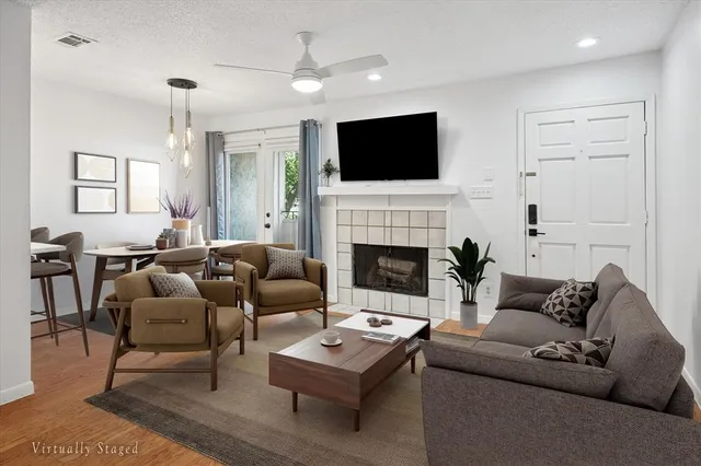 a living room with furniture fireplace and flat screen tv