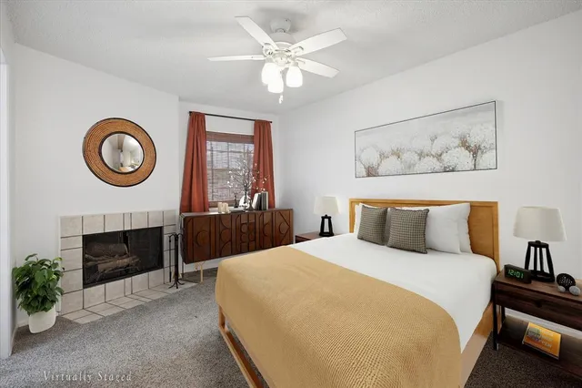 a bedroom with a bed and a fireplace