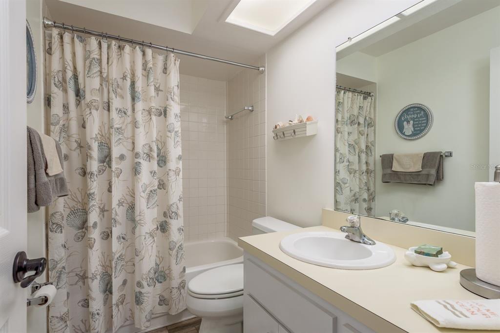 409 Stirling Terrace Dunedin, FL 34698 - Photo 13 of 17 a bathroom with a sink toilet and shower
