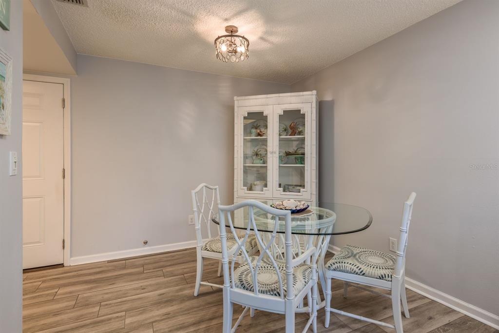 409 Stirling Terrace Dunedin, FL 34698 - Photo 6 of 17 a view of a dining room with furniture and wooden floor