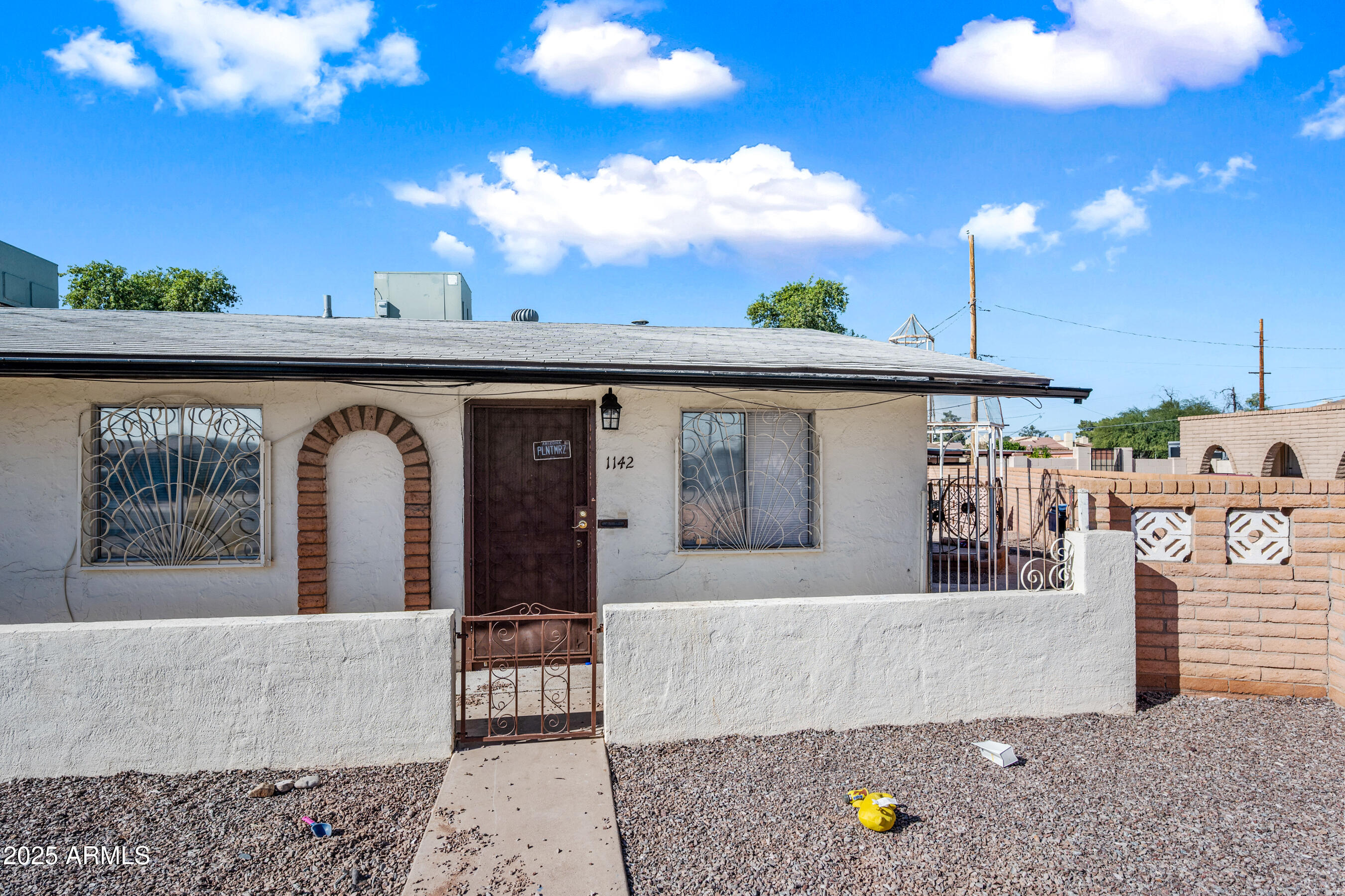 1138 North Dresden Circle Mesa, AZ 85203 - Photo 17 of 27 a front view of a house with a garden