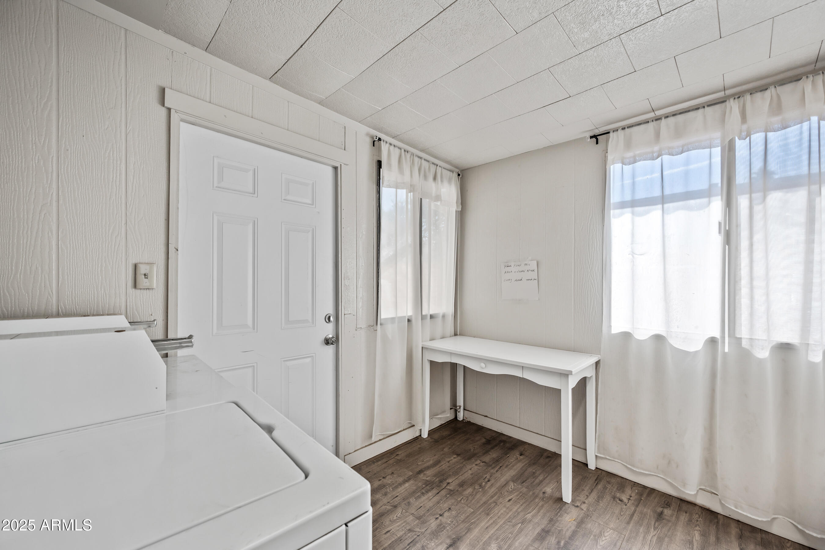 1138 North Dresden Circle Mesa, AZ 85203 - Photo 22 of 27 a view of an empty room with wooden floor and a window