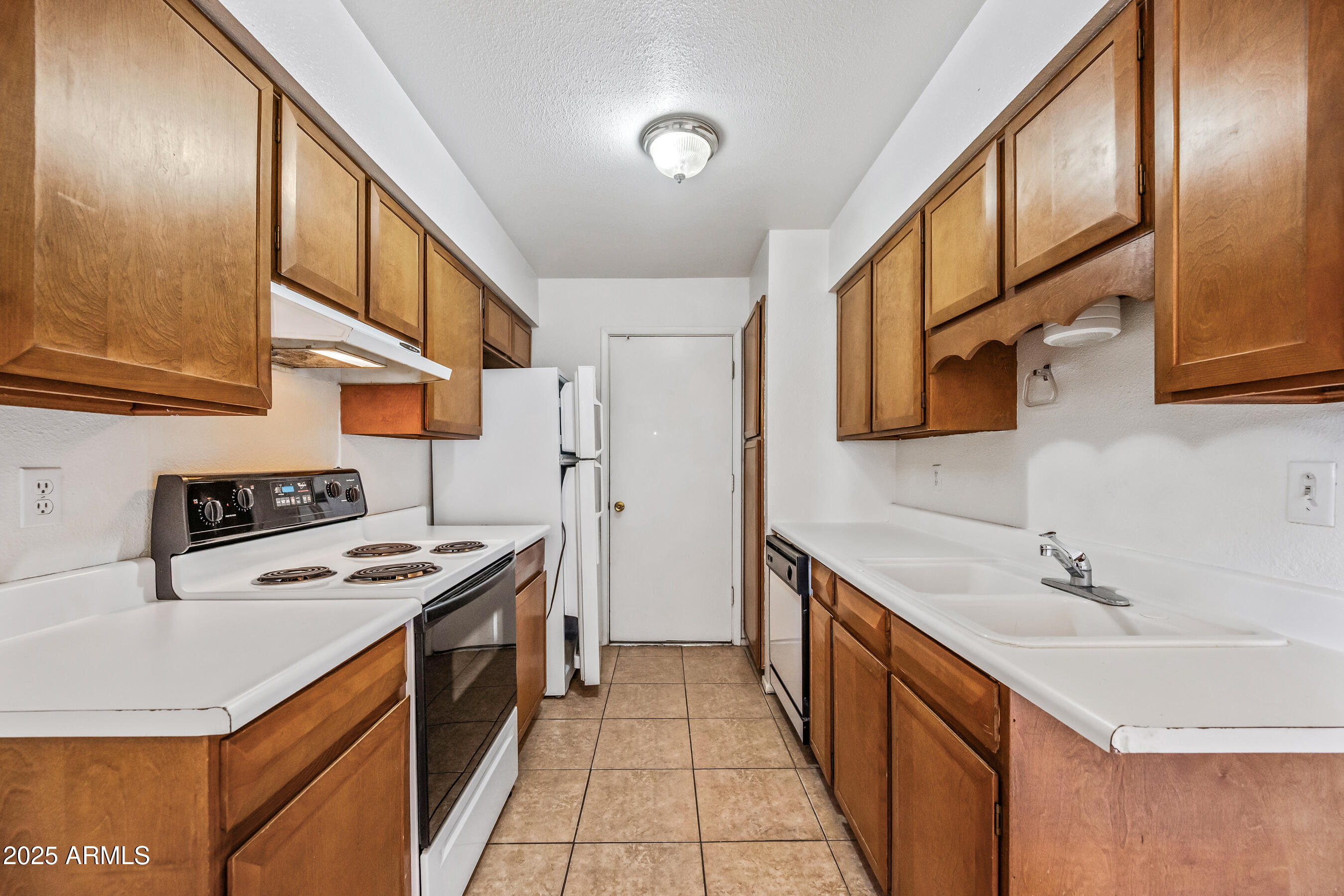 1138 North Dresden Circle Mesa, AZ 85203 - Photo 24 of 27 a kitchen with stainless steel appliances granite countertop a sink and a stove