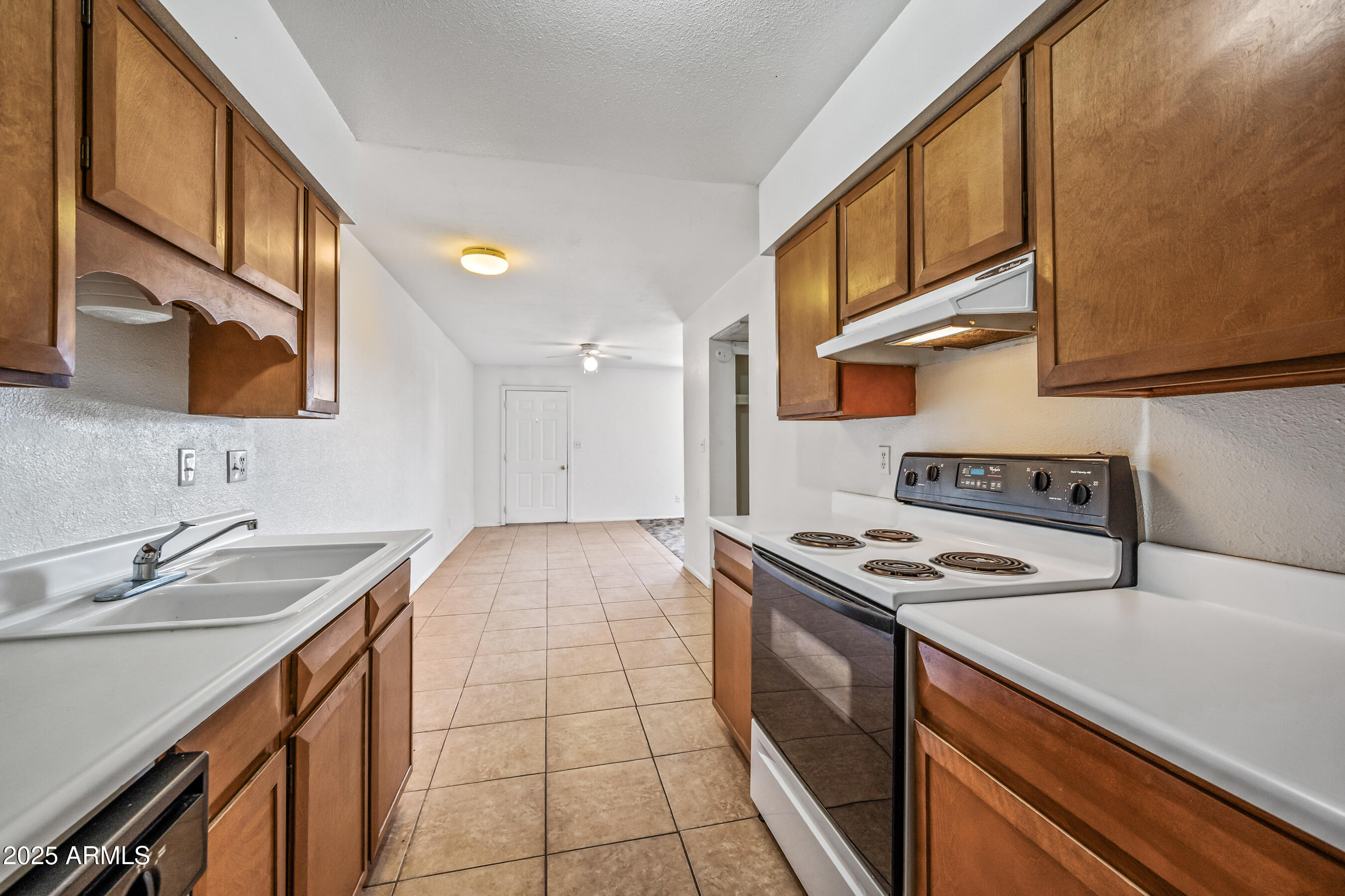 1138 North Dresden Circle Mesa, AZ 85203 - Photo 25 of 27 a kitchen that has a sink and a stove