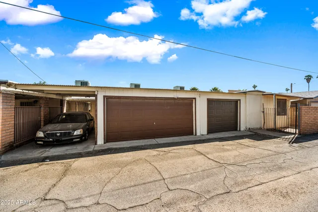 a view of garage with a car parked in it