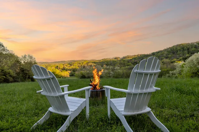 a view of a table and chairs with wooden floor and fence