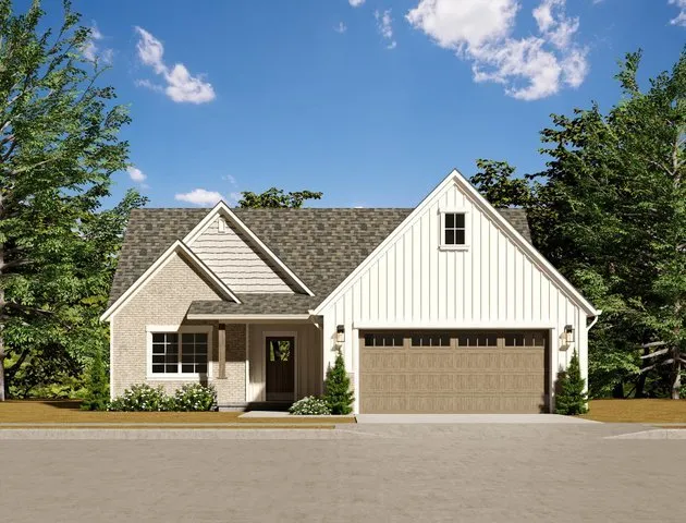 a view of house with garage and yard