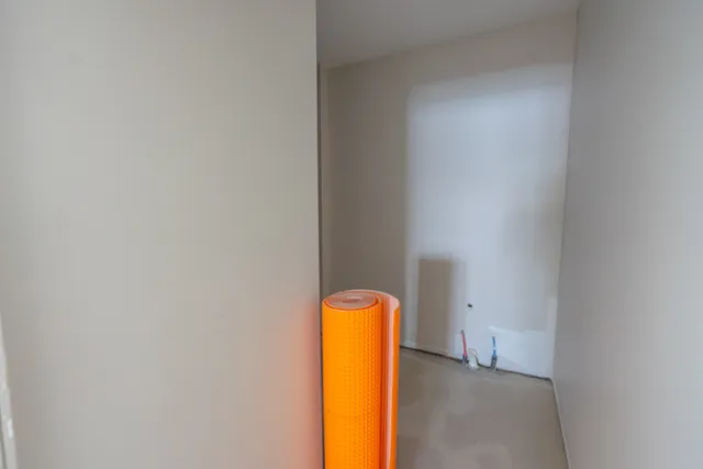 a large kitchen with stainless steel appliances granite countertop a refrigerator a sink dishwasher a dining table and chairs with wooden floor