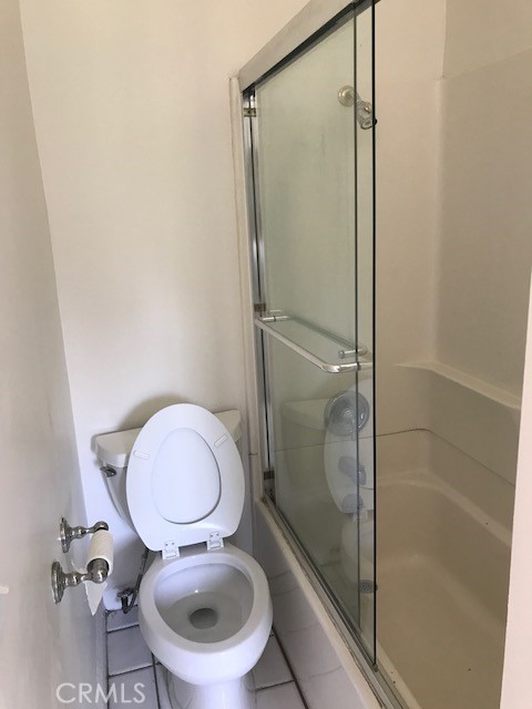 1624 South Gramercy Place Los Angeles, CA 90019 - Photo 12 of 20 a bathroom with a granite countertop toilet and a shower
