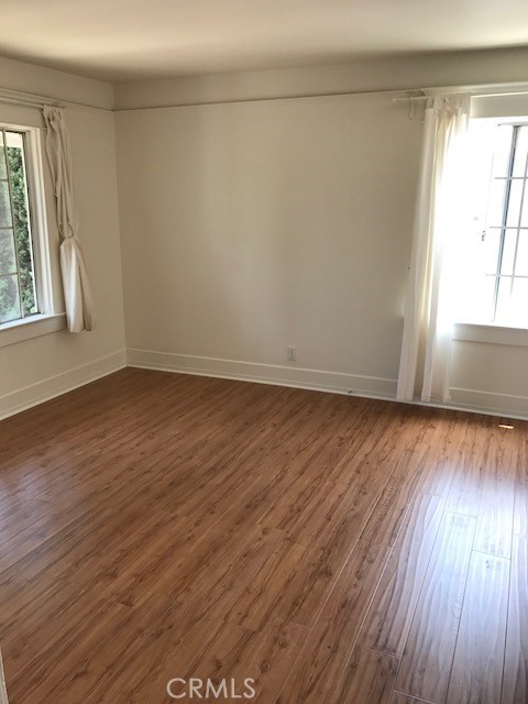 1624 South Gramercy Place Los Angeles, CA 90019 - Photo 15 of 20 wooden floor in an empty room with a window