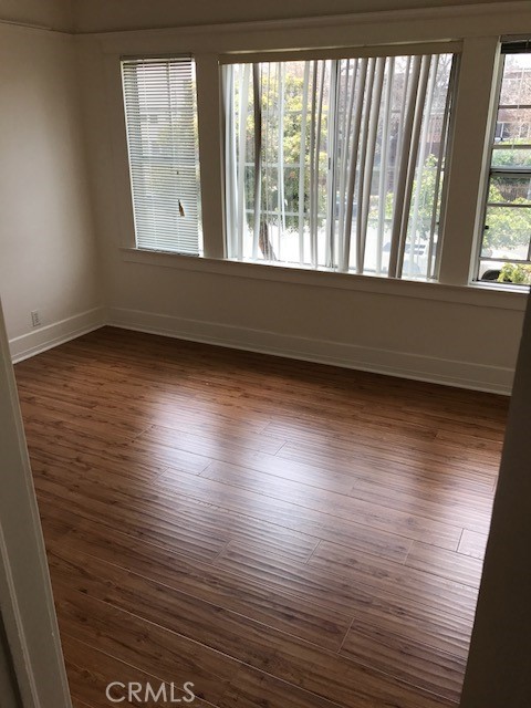 1624 South Gramercy Place Los Angeles, CA 90019 - Photo 20 of 20 an empty room with wooden floor and windows