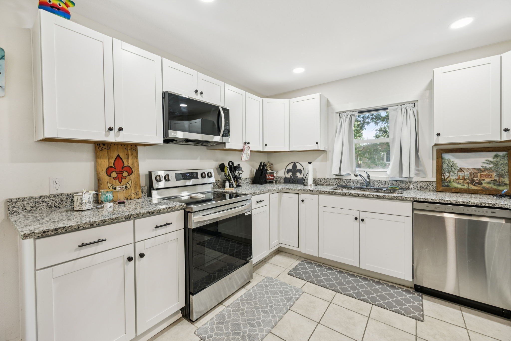 630 Lakeview Court Tennessee Ridge, TN 37178 - Photo 12 of 76 a kitchen with granite countertop white cabinets stainless steel appliances with a sink and dishwasher