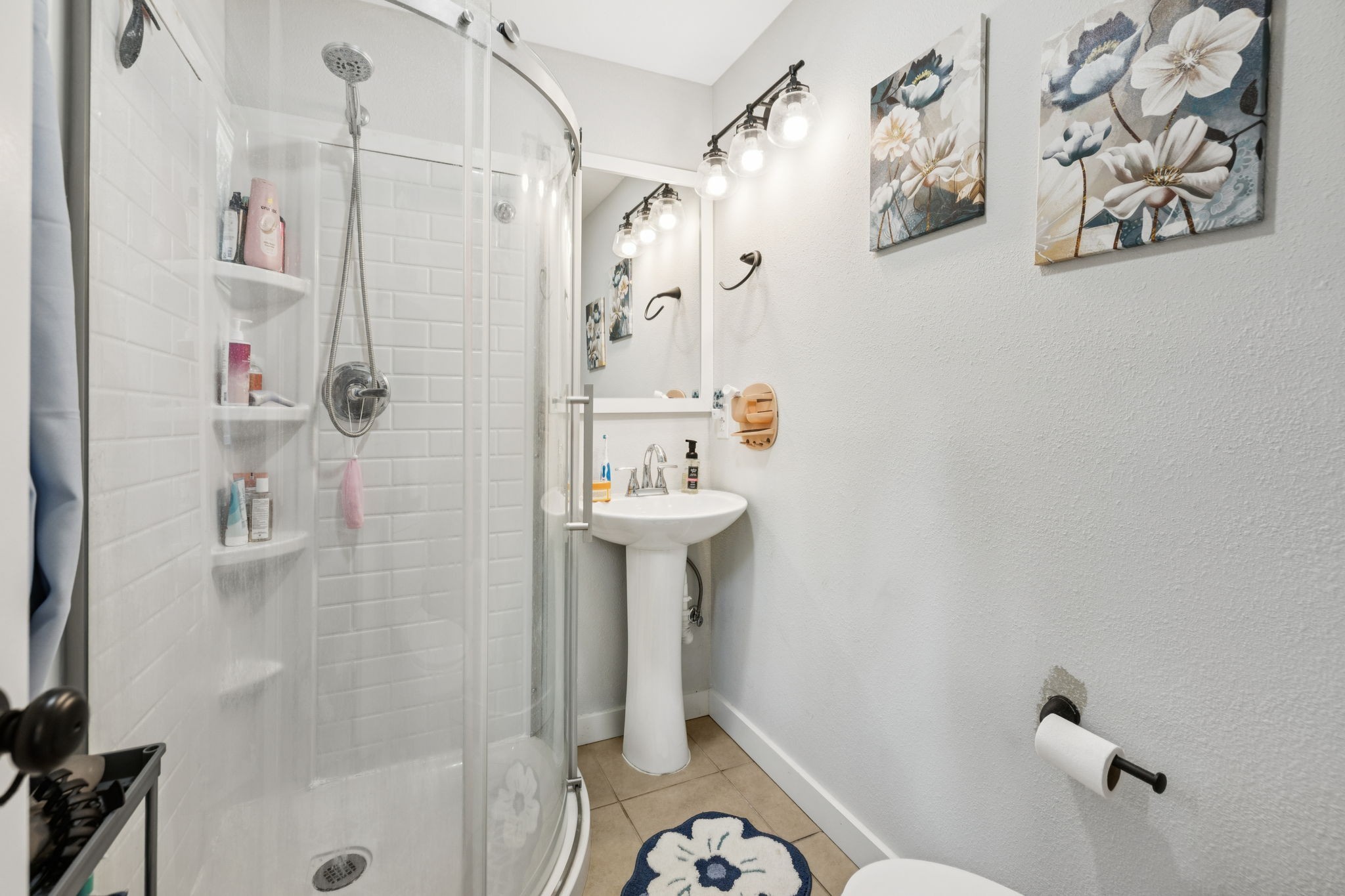 630 Lakeview Court Tennessee Ridge, TN 37178 - Photo 17 of 76 a bathroom with a sink a mirror and shower