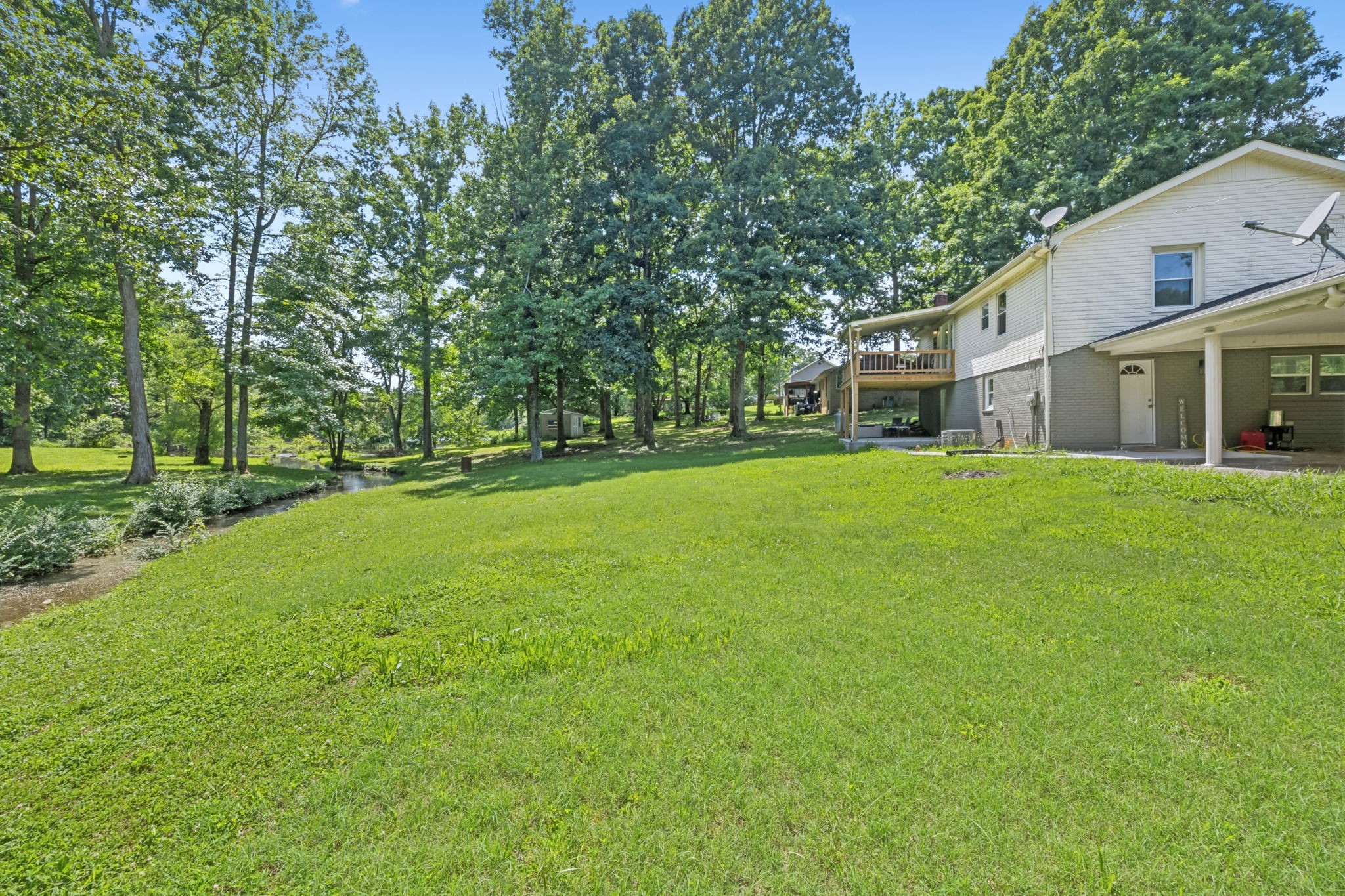630 Lakeview Court Tennessee Ridge, TN 37178 - Photo 33 of 76 a view of a house with a big yard and large trees