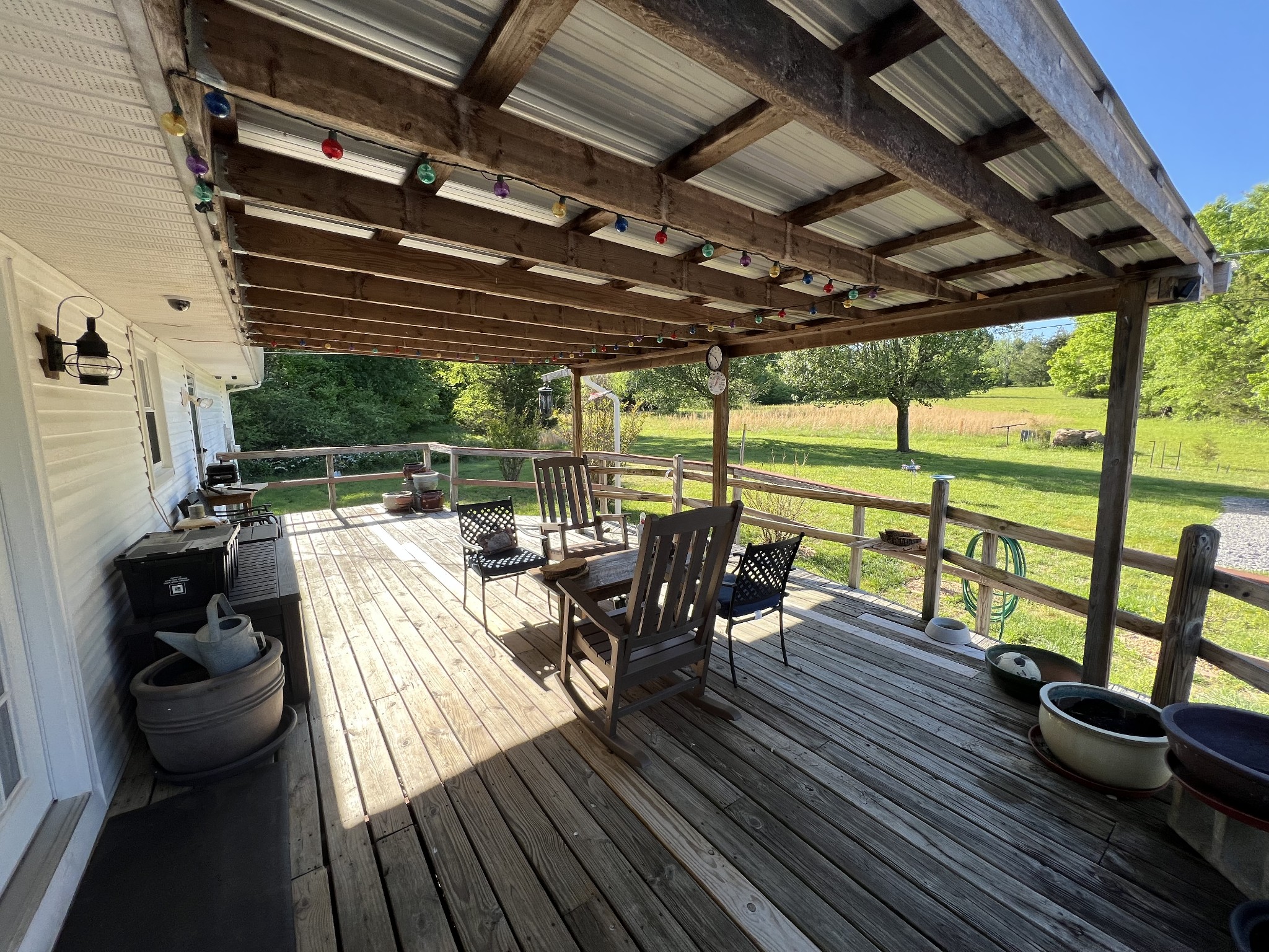 810 Rabbit Branch Road Shelbyville, TN 37160 - Photo 8 of 17 a view of a chairs and table in patio with wooden floor