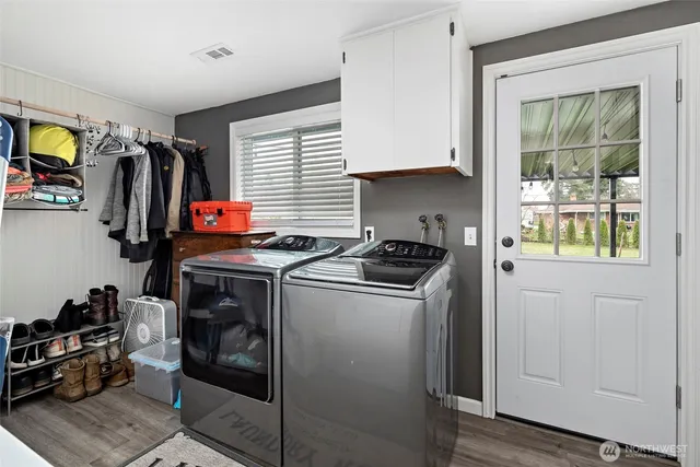 a view of a storage and utility room with washer and dryer