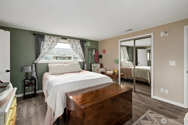 a bedroom with a bed and a large window