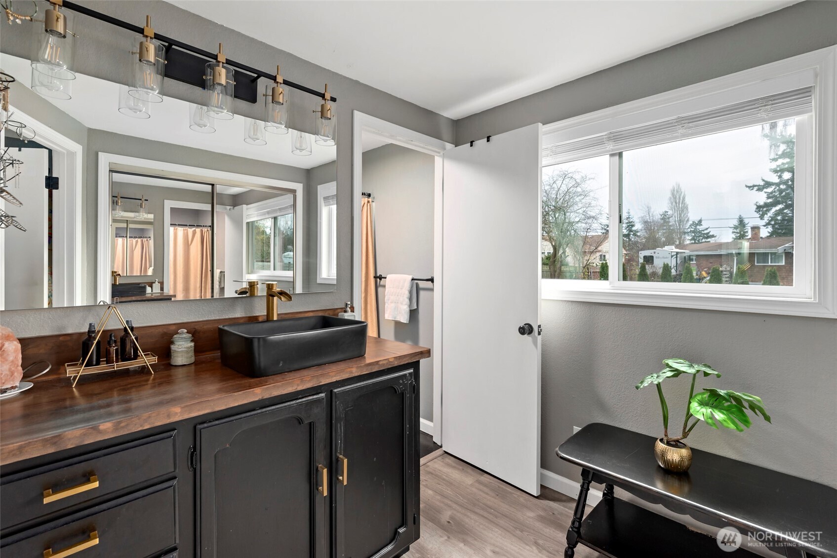 541 Southeast 5th Avenue Oak Harbor, WA 98277 - Photo 19 of 35 a bathroom with a granite countertop sink a toilet and a large mirror
