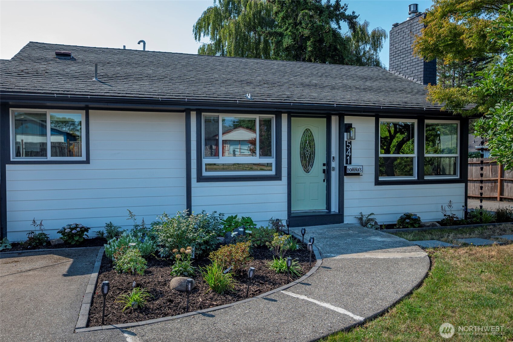 541 Southeast 5th Avenue Oak Harbor, WA 98277 - Photo 2 of 35 a view of a barn with a yard potted plants and a table
