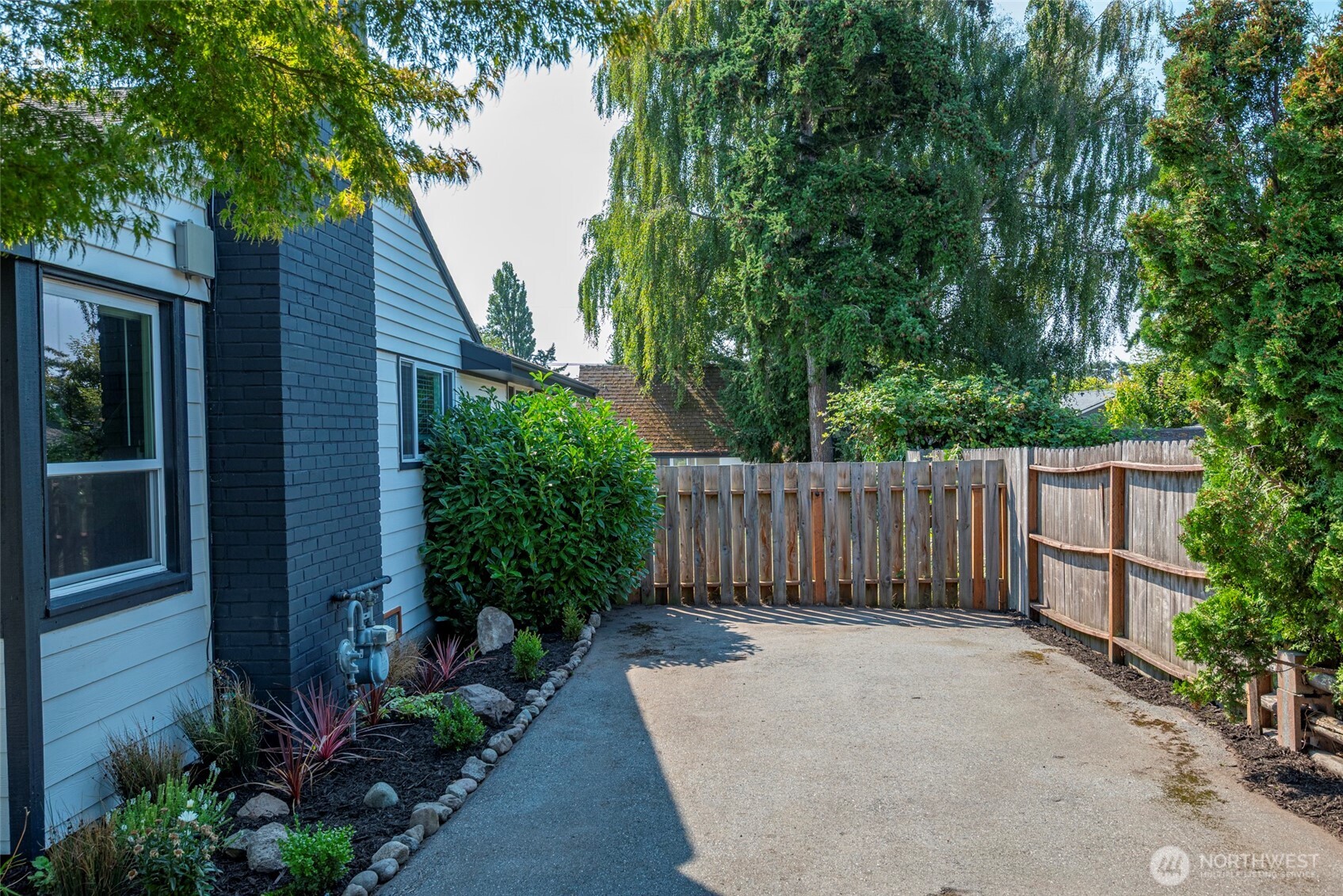 541 Southeast 5th Avenue Oak Harbor, WA 98277 - Photo 27 of 35 a view of a backyard with potted plants and large tree