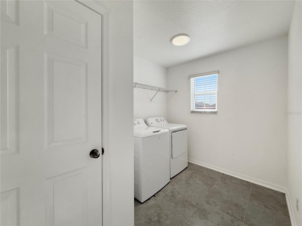 3023 Adams Cross Drive Zephyrhills, FL 33540 - Photo 13 of 36 a utility room with dryer and washer