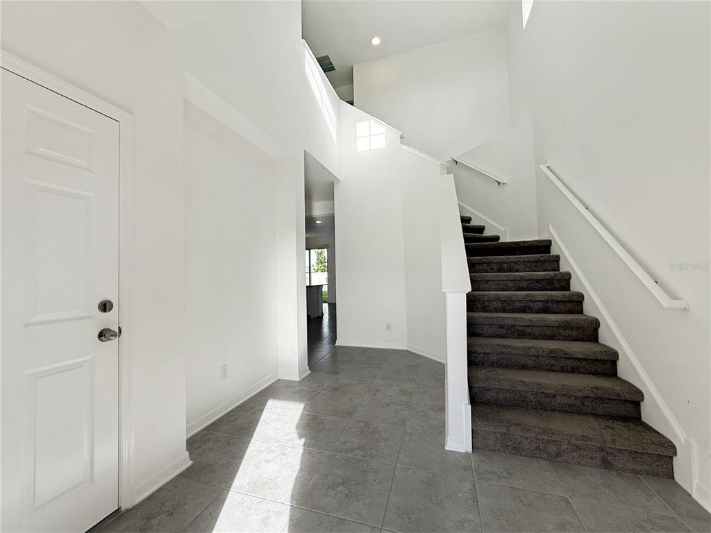 3023 Adams Cross Drive Zephyrhills, FL 33540 - Photo 16 of 36 a view of entryway and hall