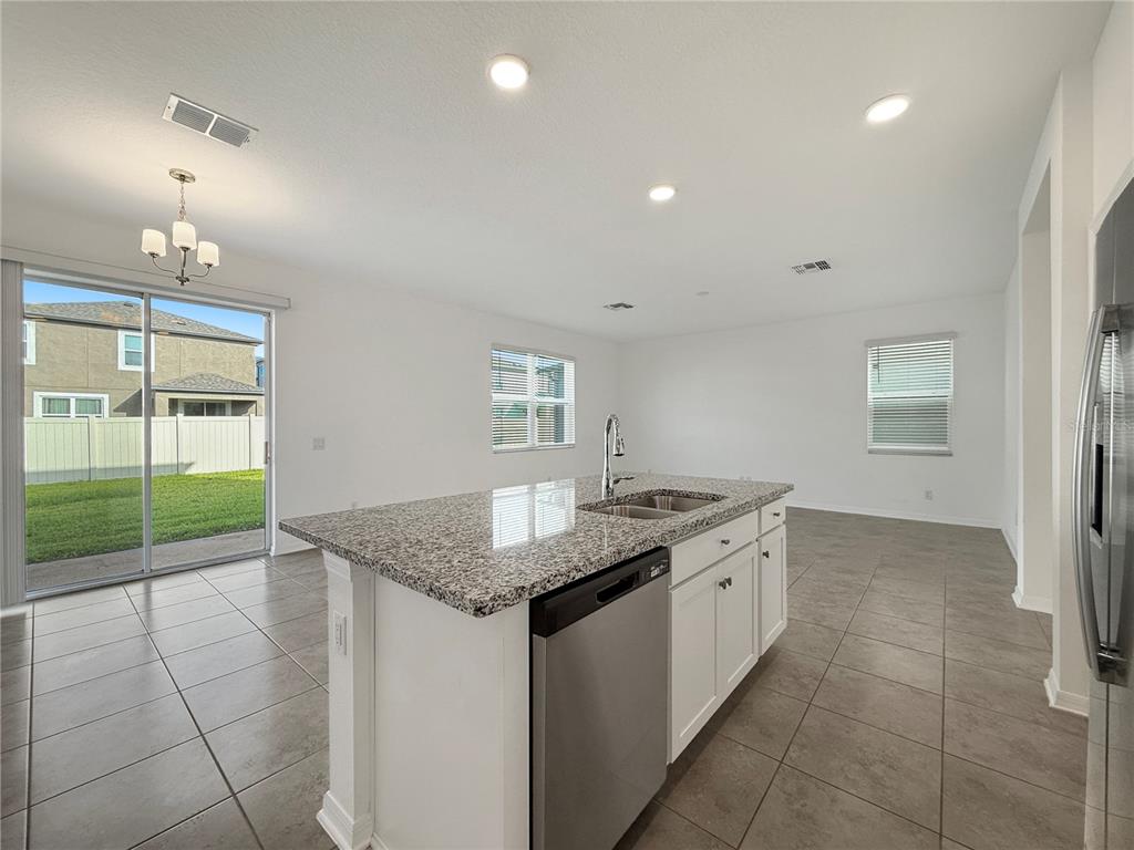 3023 Adams Cross Drive Zephyrhills, FL 33540 - Photo 19 of 36 a kitchen that has a sink a stove and a window