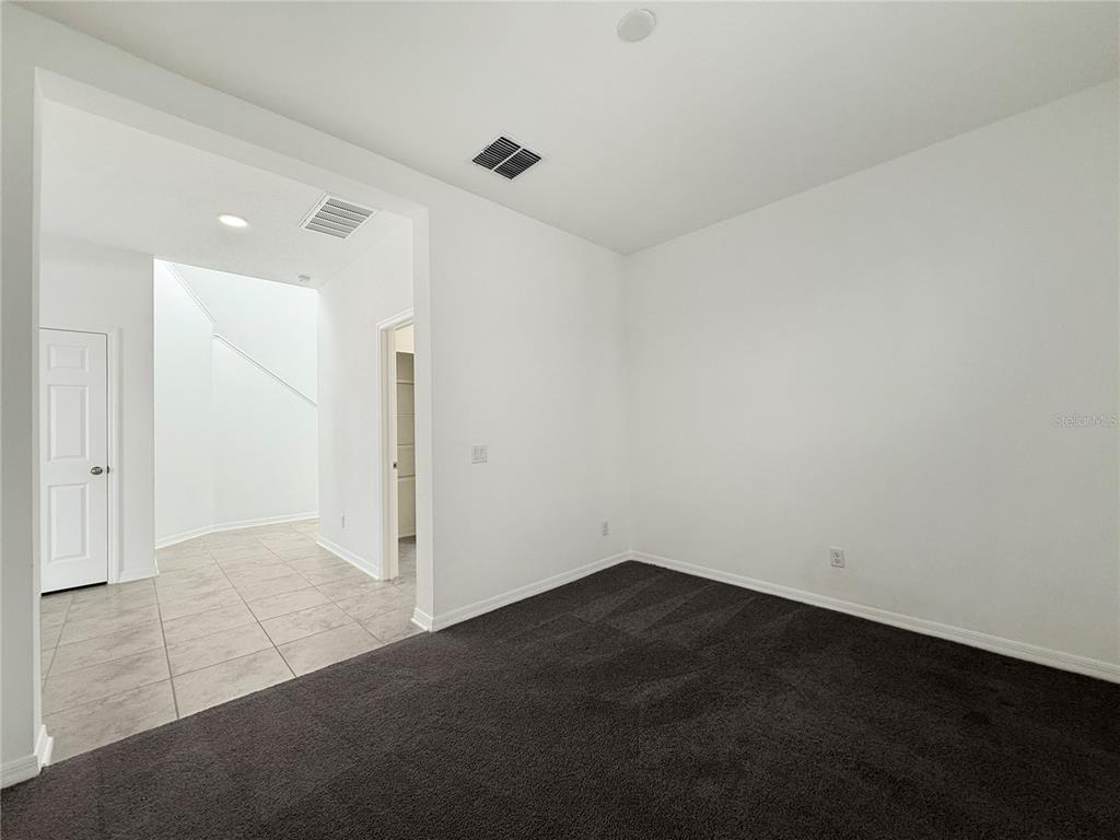 3023 Adams Cross Drive Zephyrhills, FL 33540 - Photo 20 of 36 an empty room with a ceiling fan and closet area