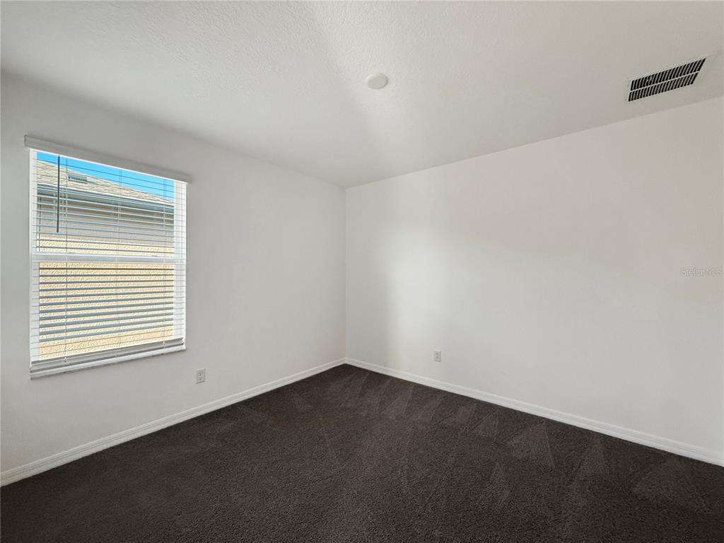 3023 Adams Cross Drive Zephyrhills, FL 33540 - Photo 24 of 36 an empty room with a window