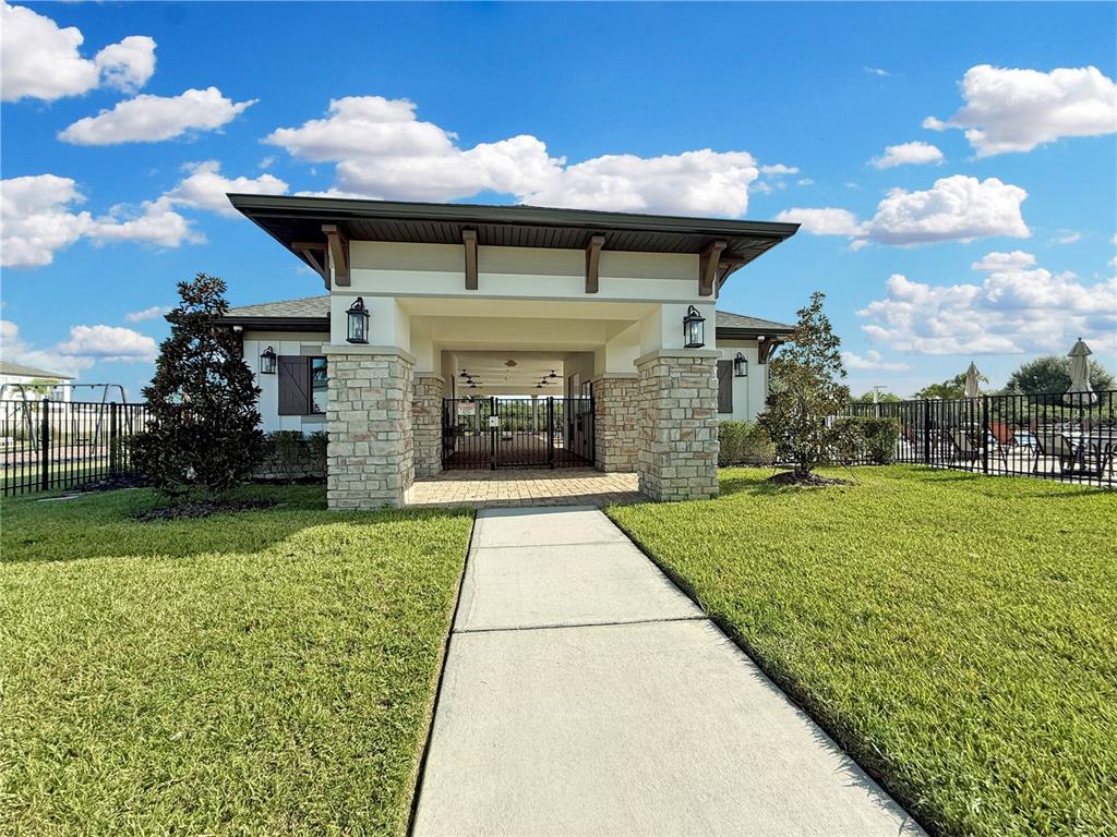 3023 Adams Cross Drive Zephyrhills, FL 33540 - Photo 30 of 36 a front view of a house with garden