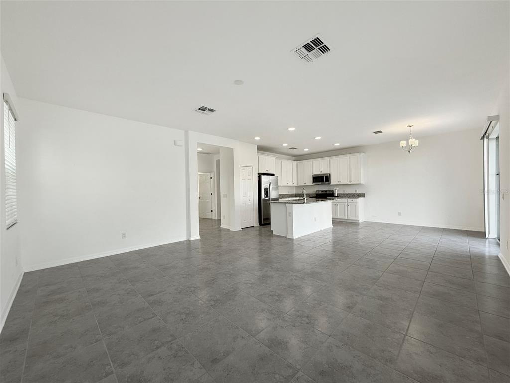 3023 Adams Cross Drive Zephyrhills, FL 33540 - Photo 4 of 36 a view of an empty room with kitchen view
