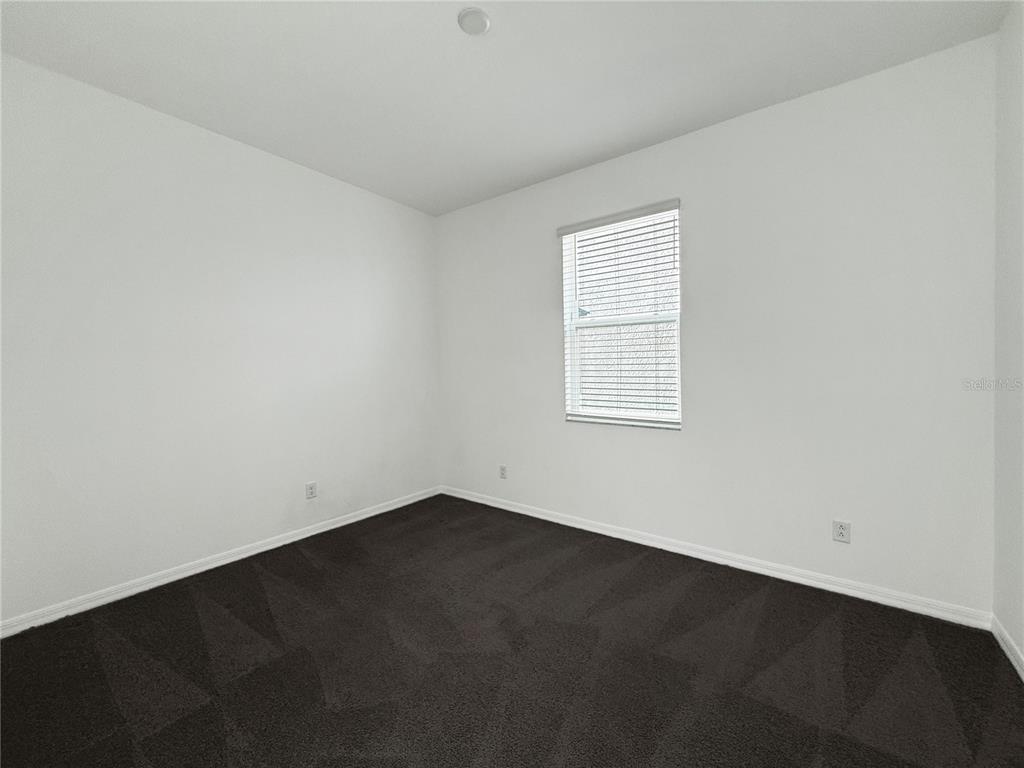 3023 Adams Cross Drive Zephyrhills, FL 33540 - Photo 6 of 36 an empty room with a window