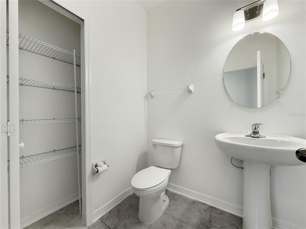 3023 Adams Cross Drive Zephyrhills, FL 33540 - Photo 7 of 36 a bathroom with a toilet sink and mirror