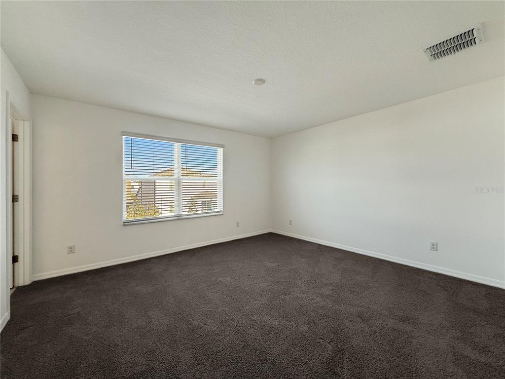 3023 Adams Cross Drive Zephyrhills, FL 33540 - Photo 9 of 36 an empty room with a window