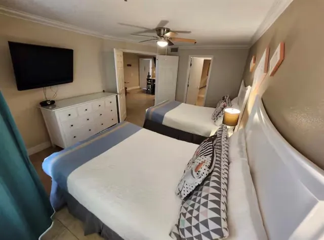 a bedroom with furniture and a flat screen tv