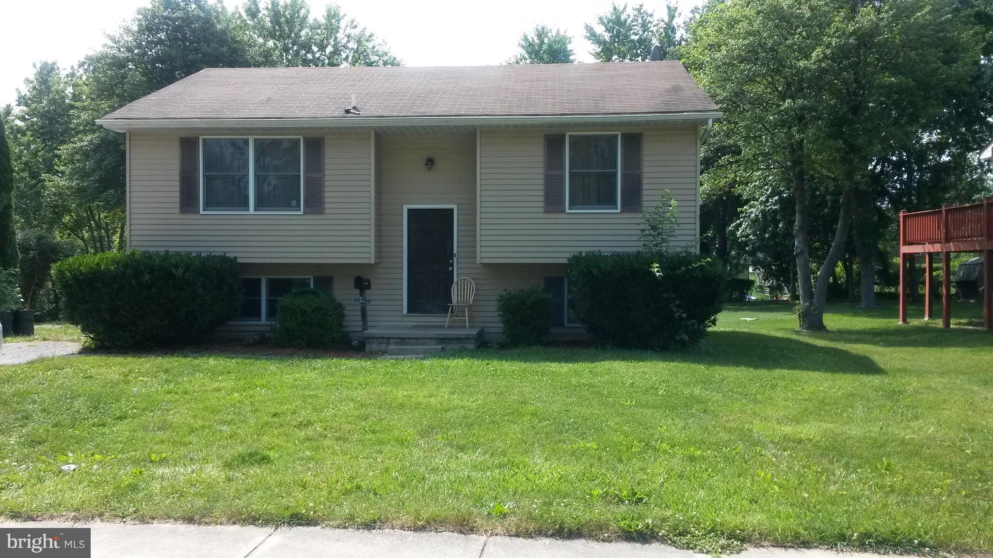 3608 Rusty Rock Road Randallstown, MD 21133 - Photo 1 of 2 a front view of a house with a garden