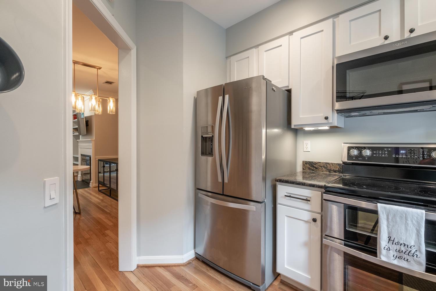 1221 Portner Road Alexandria, VA 22314 - Photo 15 of 34 a kitchen with granite countertop a refrigerator and a stove top oven