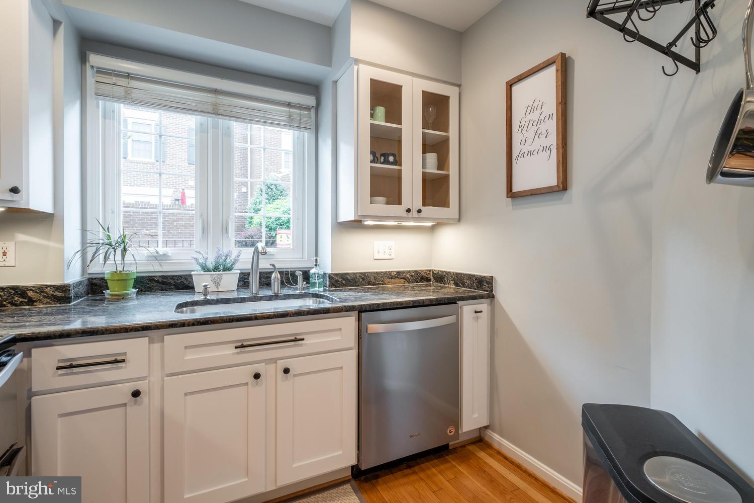 1221 Portner Road Alexandria, VA 22314 - Photo 16 of 34 a kitchen with stainless steel appliances granite countertop white cabinets a sink and a window