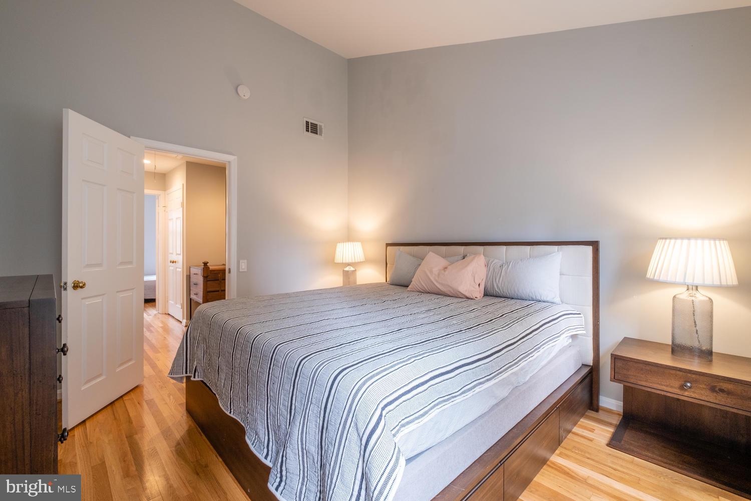 1221 Portner Road Alexandria, VA 22314 - Photo 18 of 34 a bedroom with a bed and a lamp