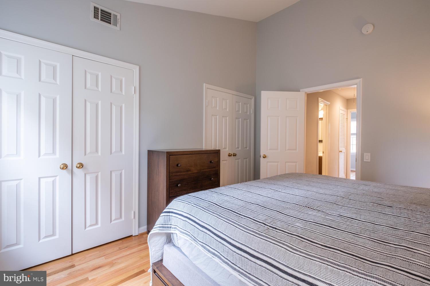 1221 Portner Road Alexandria, VA 22314 - Photo 19 of 34 a bedroom with a bed and wooden floor