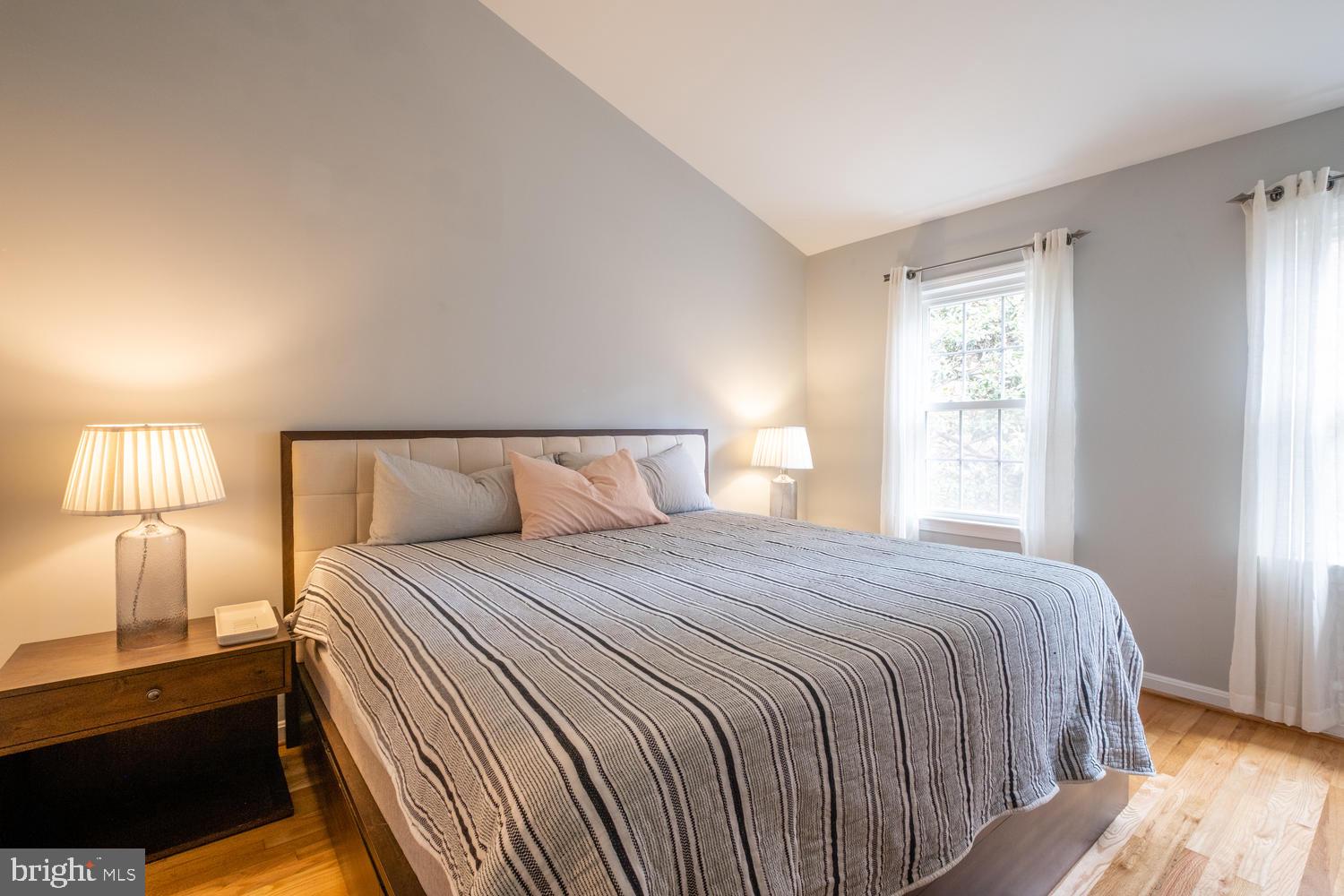 1221 Portner Road Alexandria, VA 22314 - Photo 20 of 34 a bedroom with a bed and a lamp