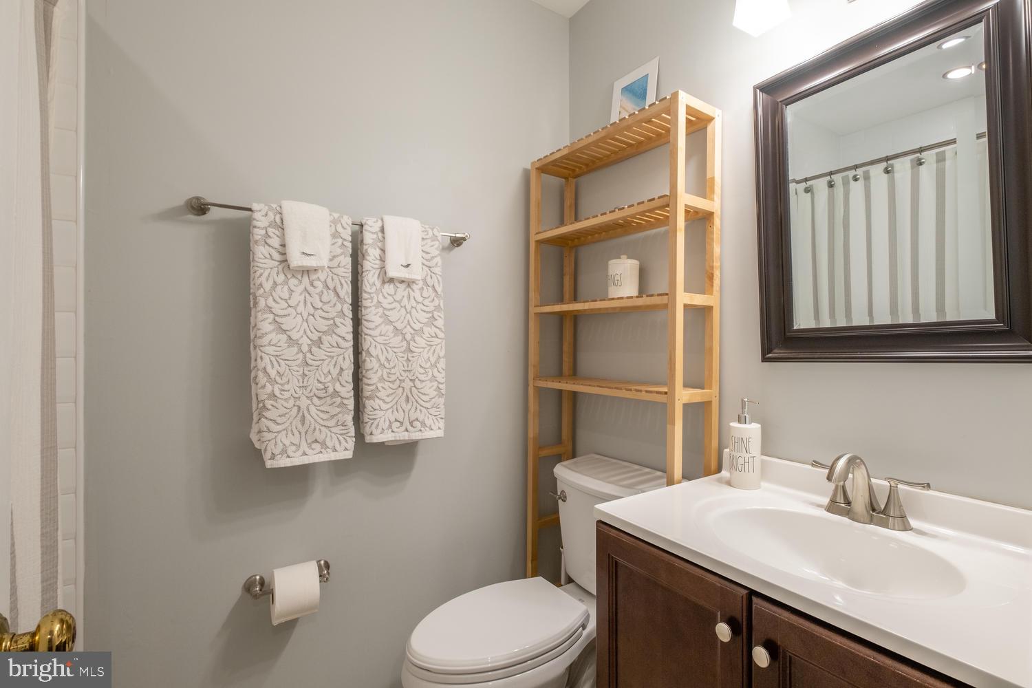 1221 Portner Road Alexandria, VA 22314 - Photo 23 of 34 a bathroom with a sink toilet and mirror