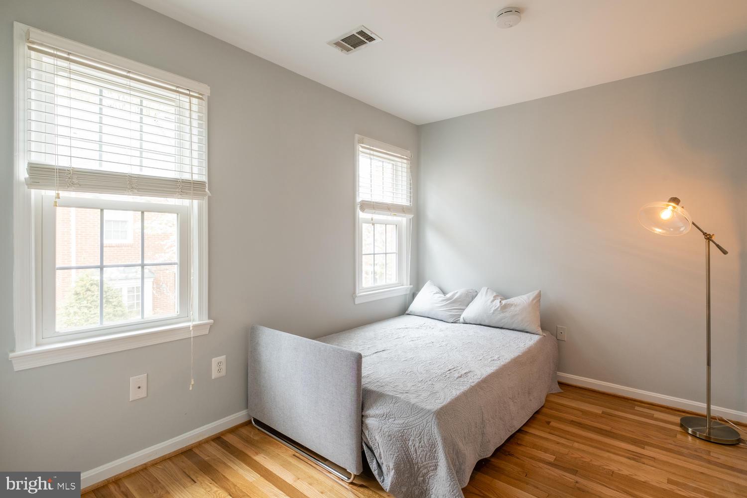 1221 Portner Road Alexandria, VA 22314 - Photo 25 of 34 a bedroom with a bed and wooden floor