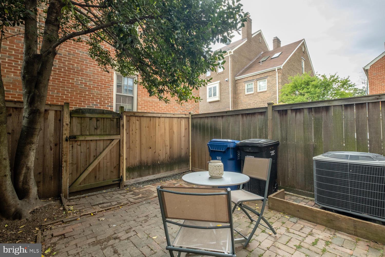1221 Portner Road Alexandria, VA 22314 - Photo 29 of 34 a view of a patio with table and chairs with wooden fence