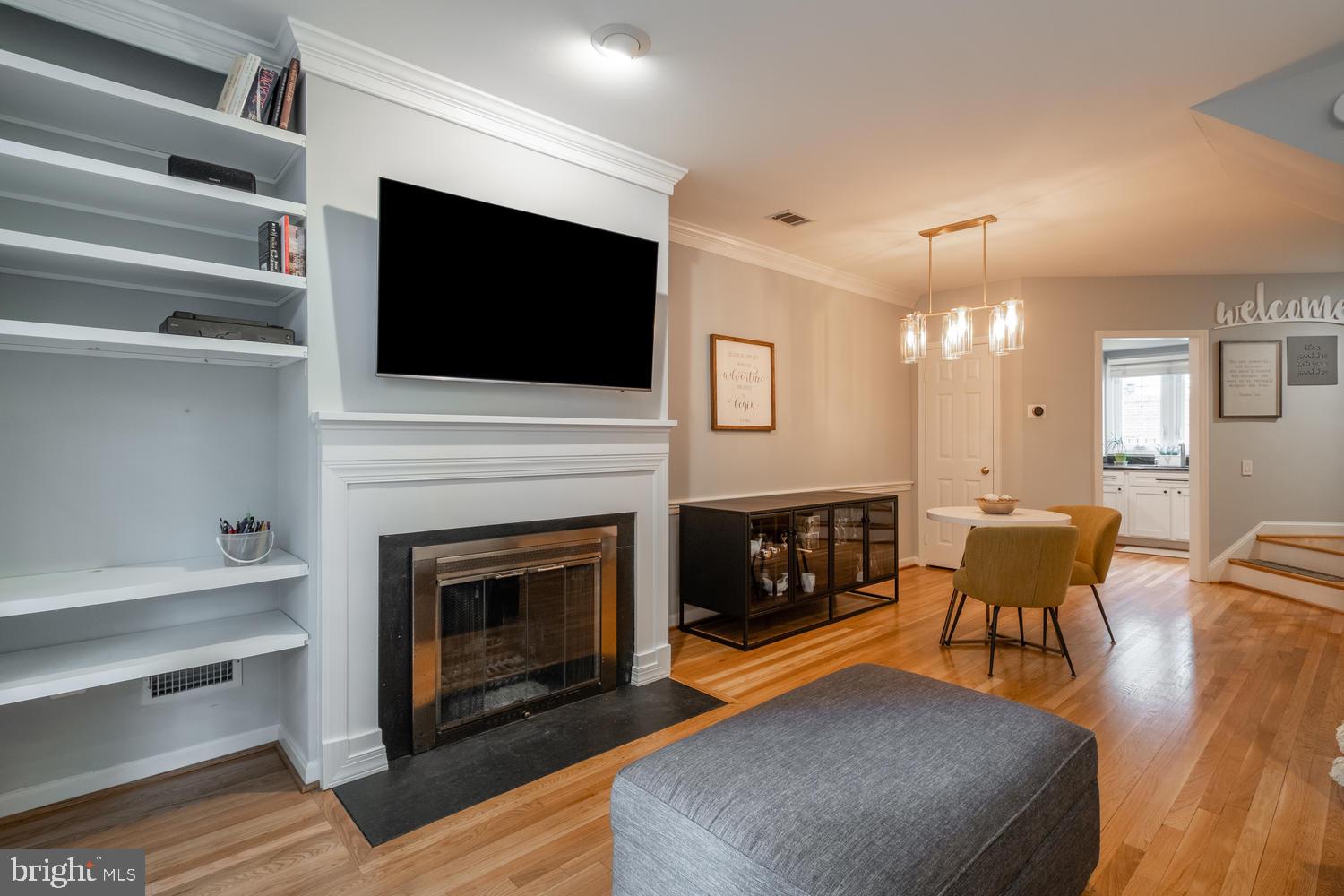 1221 Portner Road Alexandria, VA 22314 - Photo 5 of 34 a living room with furniture a flat screen tv and a fireplace