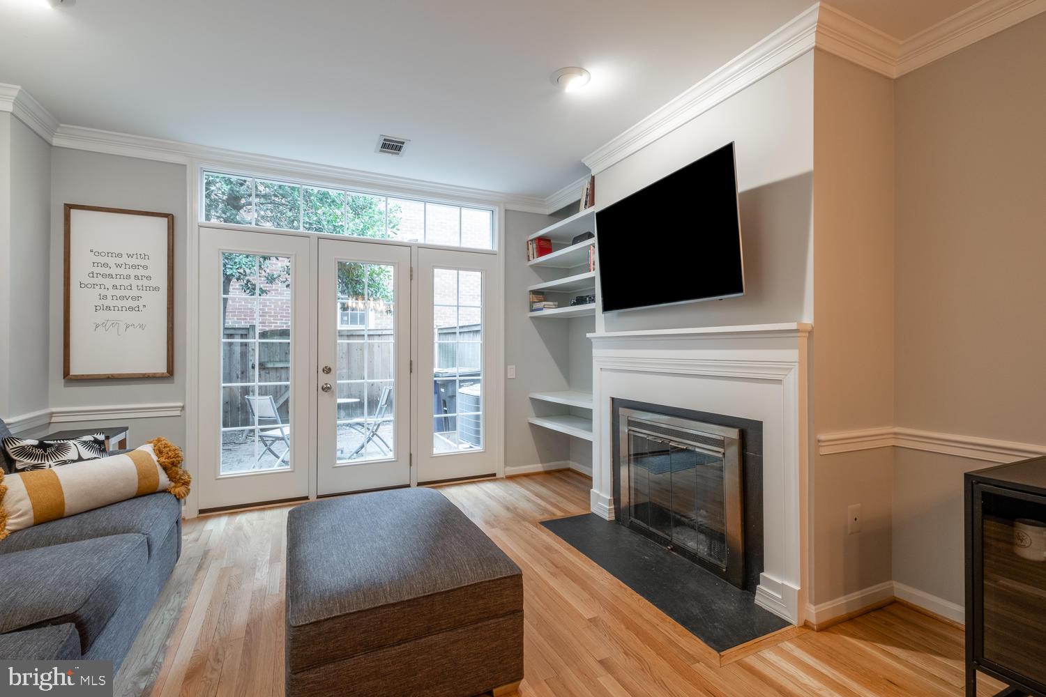 1221 Portner Road Alexandria, VA 22314 - Photo 7 of 34 a living room with furniture a flat screen tv and a fireplace