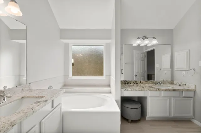 a bathroom with a sink double vanity and a mirror