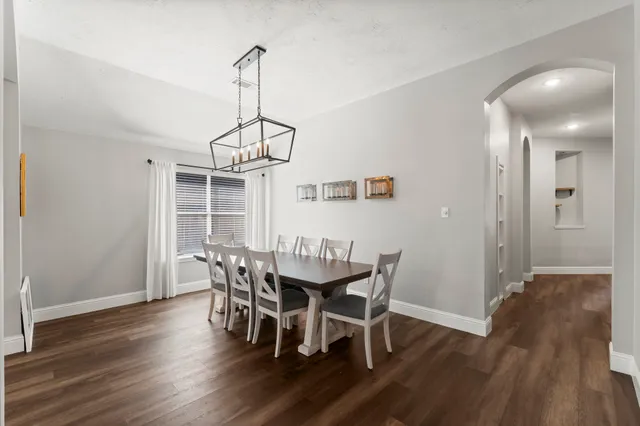 a view of a dining room with furniture wooden floor and chandelier