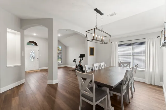 a view of a dining room with furniture window and wooden floor